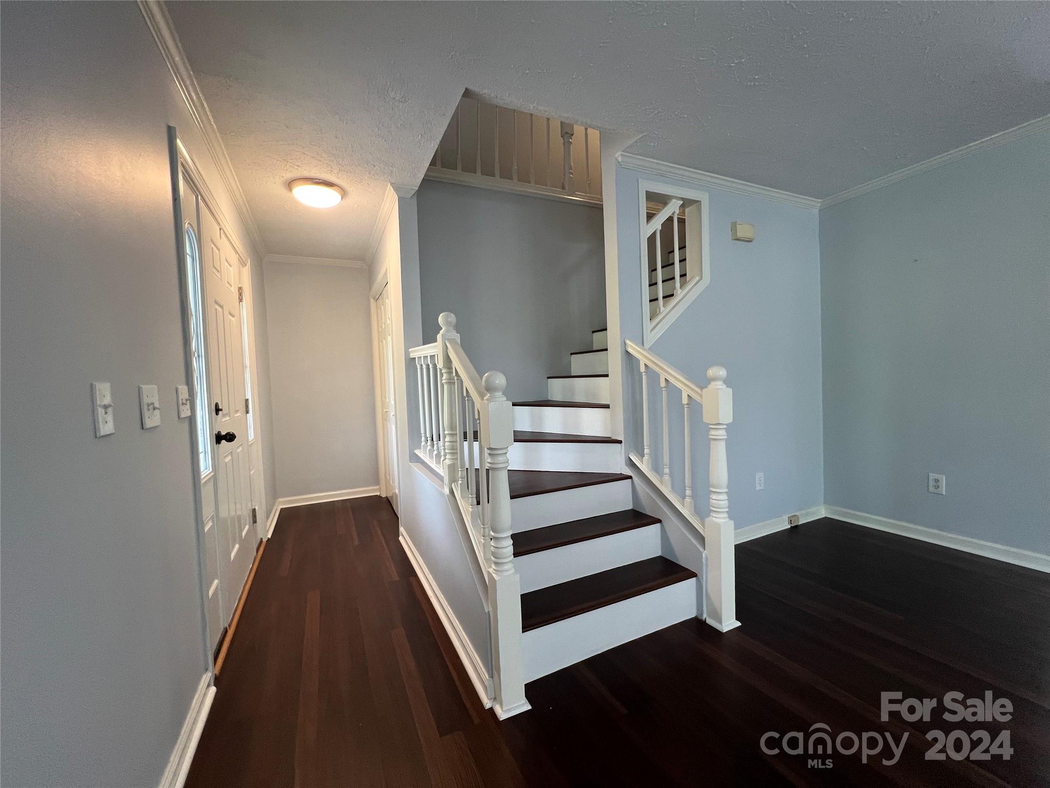 148 Riff Drive Forest City, NC 28043 - Photo 9 of 40 a view of a hallway with wooden floor and stairs