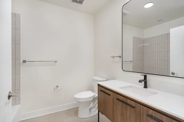 a bathroom with a sink toilet and vanity