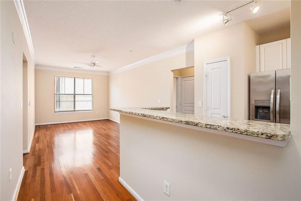 10 Perimeter Summit Boulevard, Unit 3301 Atlanta, GA 30319 - Photo 11 of 36 a view of an empty room with a window and wooden floor