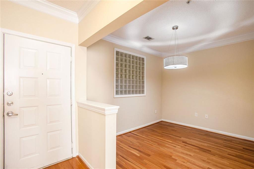 10 Perimeter Summit Boulevard, Unit 3301 Atlanta, GA 30319 - Photo 12 of 36 an empty room with wooden floor and windows