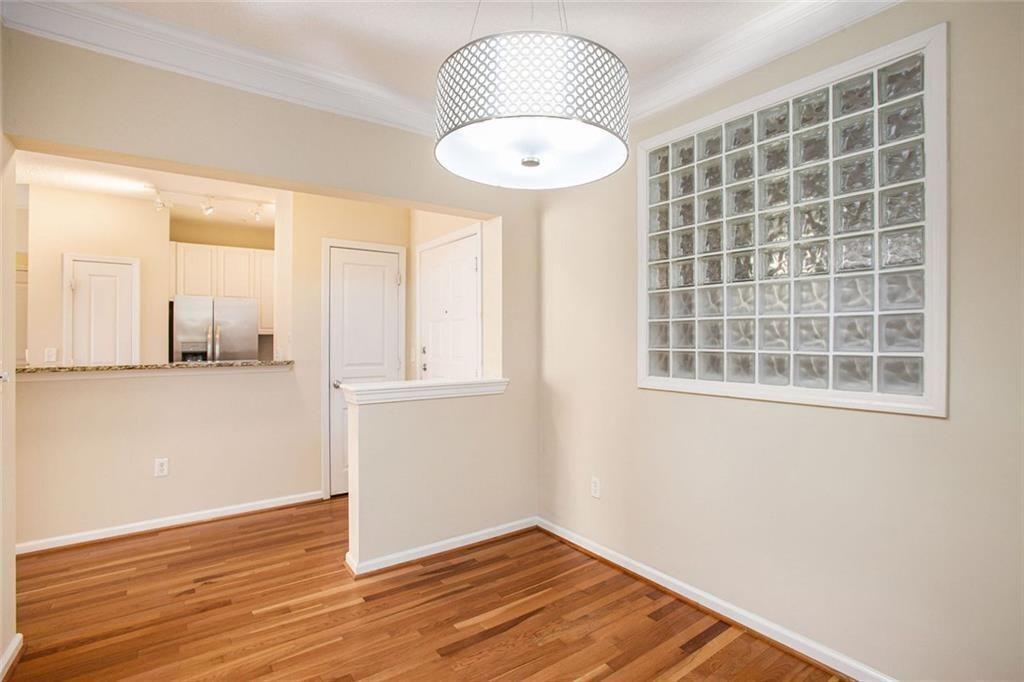 10 Perimeter Summit Boulevard, Unit 3301 Atlanta, GA 30319 - Photo 13 of 36 an empty room with wooden floor and windows
