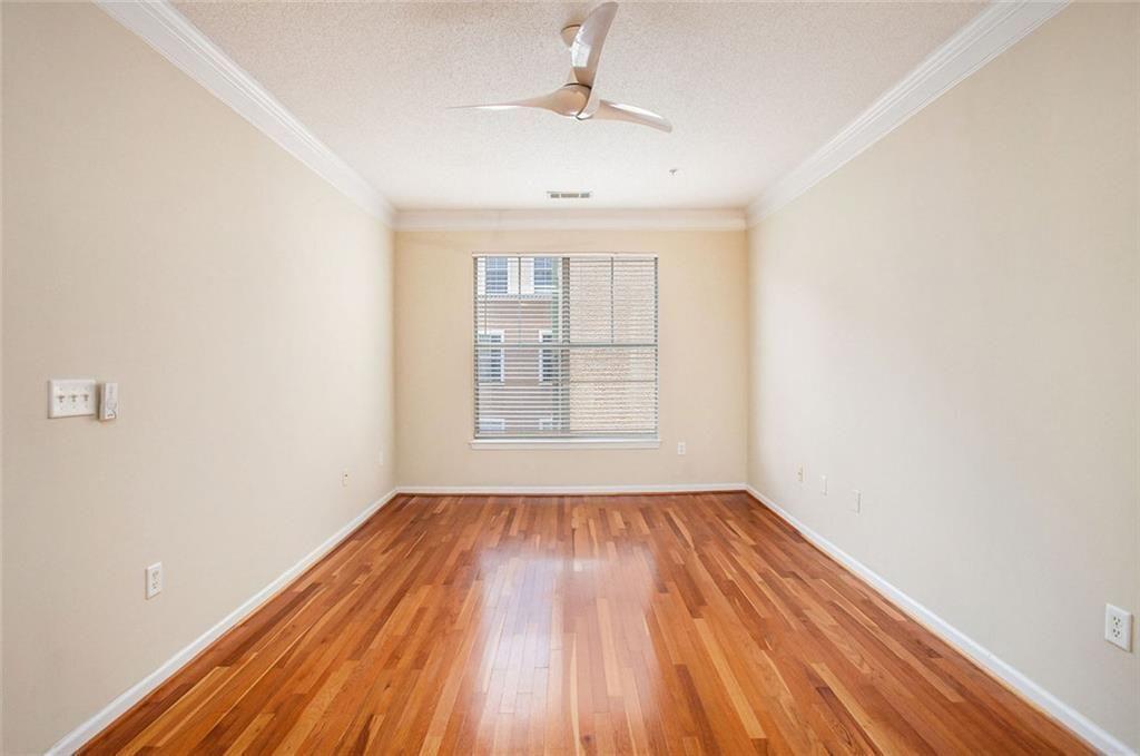 10 Perimeter Summit Boulevard, Unit 3301 Atlanta, GA 30319 - Photo 14 of 36 a view of empty room with wooden floor and fan