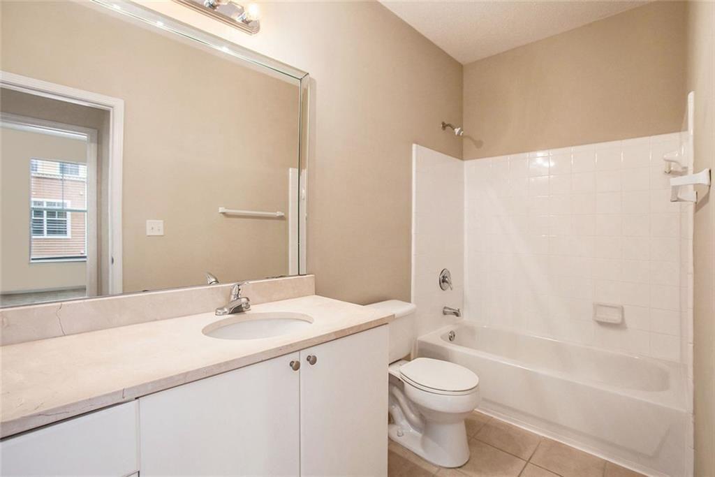 10 Perimeter Summit Boulevard, Unit 3301 Atlanta, GA 30319 - Photo 18 of 36 a bathroom with a sink a toilet and shower