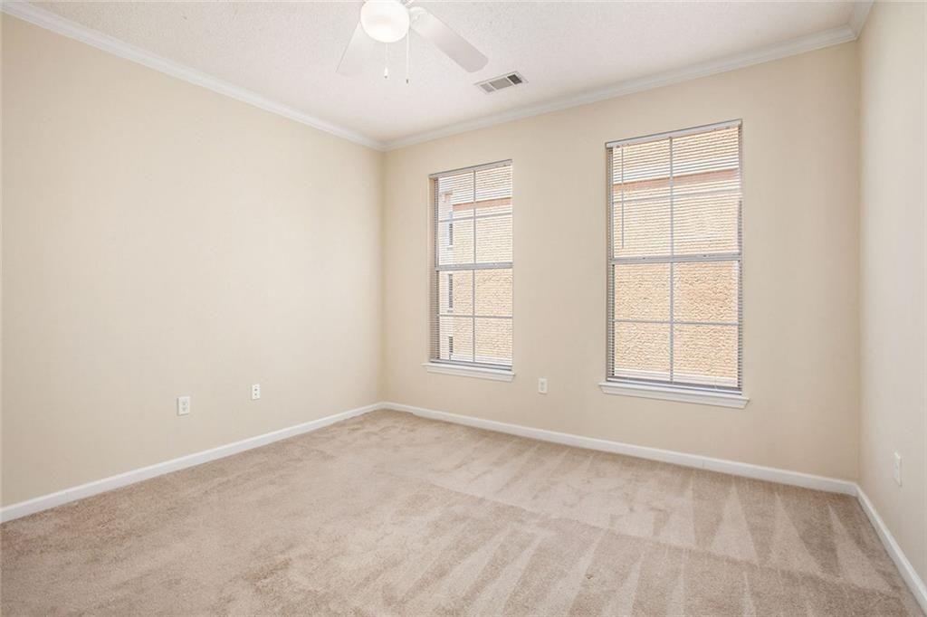 10 Perimeter Summit Boulevard, Unit 3301 Atlanta, GA 30319 - Photo 20 of 36 an empty room with windows and closet