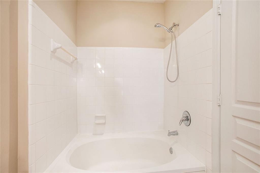 10 Perimeter Summit Boulevard, Unit 3301 Atlanta, GA 30319 - Photo 26 of 36 a bathroom with a bath tub with a shower