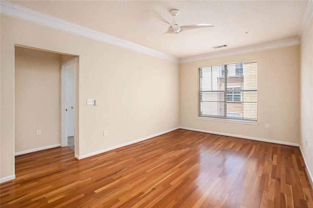 10 Perimeter Summit Boulevard, Unit 3301 Atlanta, GA 30319 - Photo 3 of 36 a view of an empty room with wooden floor and a window