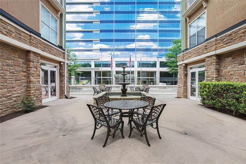 10 Perimeter Summit Boulevard, Unit 3301 Atlanta, GA 30319 - Photo 32 of 36 a patio with a table and chairs and potted plants