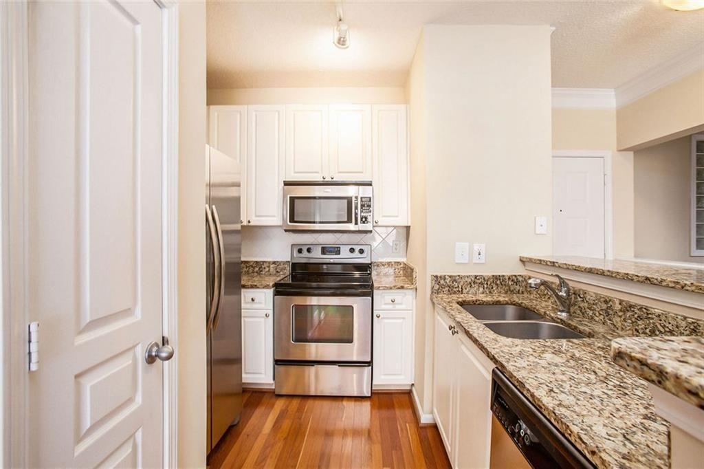 10 Perimeter Summit Boulevard, Unit 3301 Atlanta, GA 30319 - Photo 7 of 36 a kitchen with a stove and a microwave