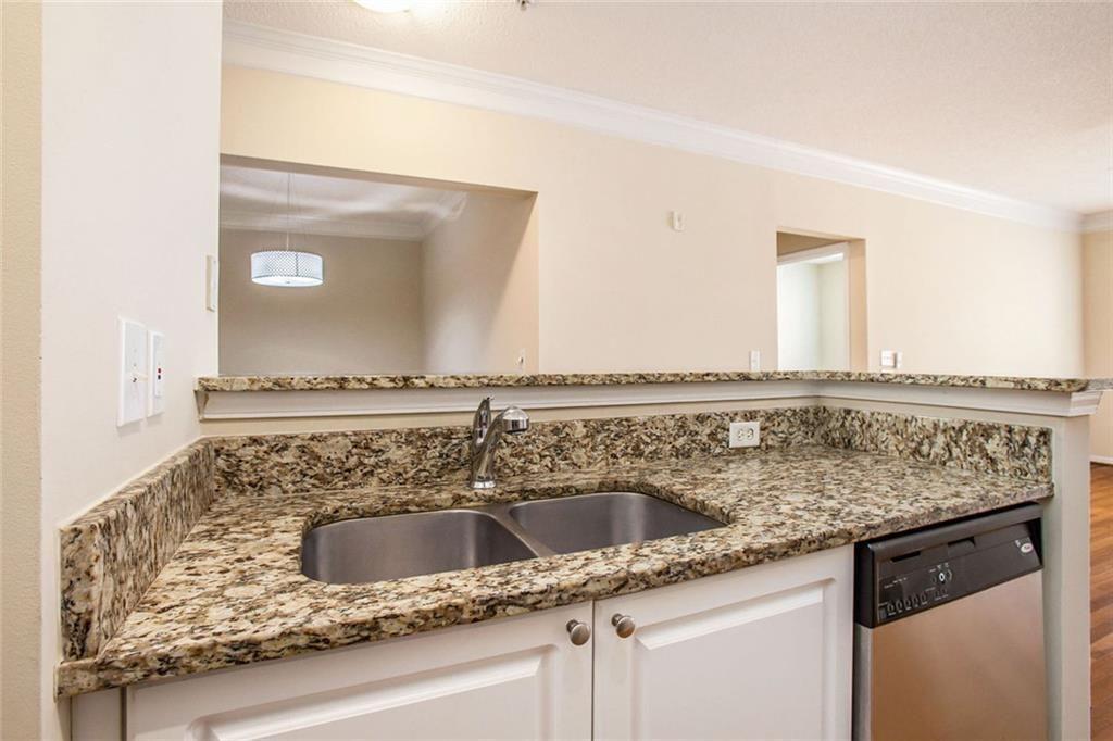 10 Perimeter Summit Boulevard, Unit 3301 Atlanta, GA 30319 - Photo 9 of 36 a bathroom with a granite countertop sink and a mirror