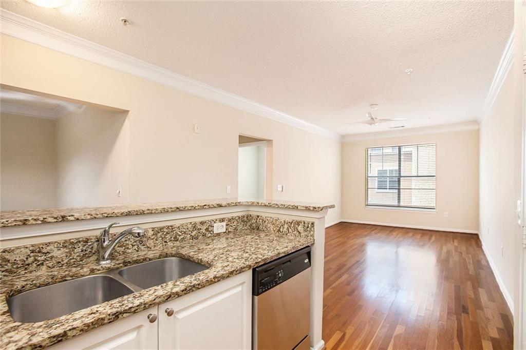 10 Perimeter Summit Boulevard, Unit 3301 Atlanta, GA 30319 - Photo 10 of 36 a view of a kitchen with a sink and wooden floor