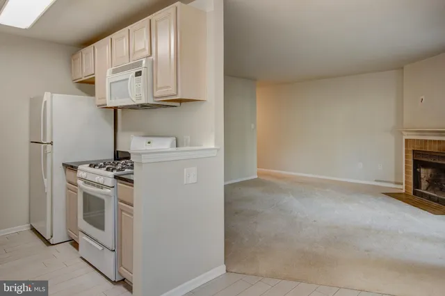 a kitchen with stainless steel appliances granite countertop a stove and a refrigerator