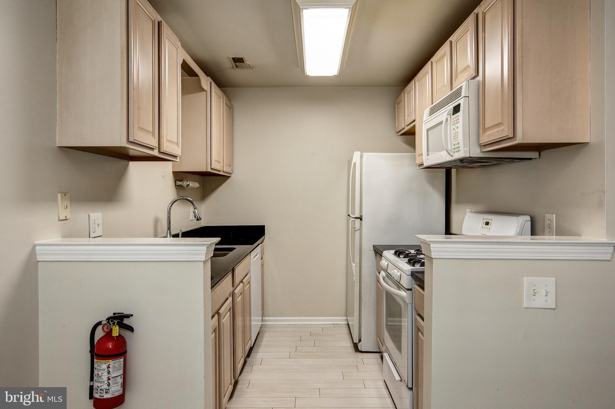 328 Tavistock Cherry Hill, NJ 08034 - Photo 12 of 23 a kitchen with stainless steel appliances granite countertop a sink stove and refrigerator