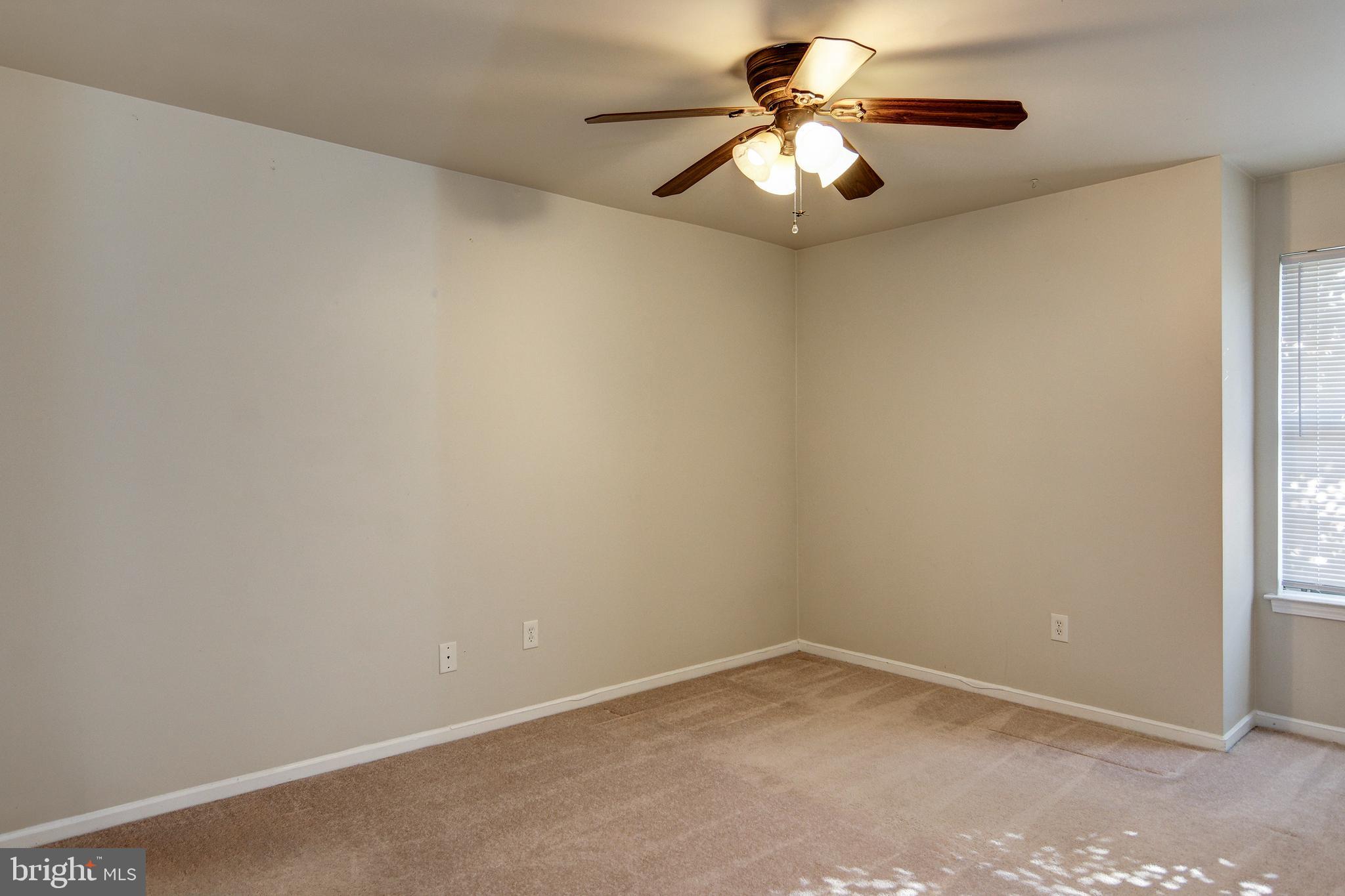 328 Tavistock Cherry Hill, NJ 08034 - Photo 16 of 23 an empty room with a window and a fan