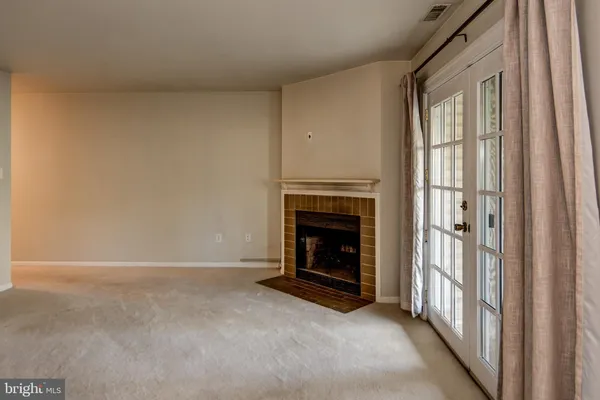 a view of empty room with windows and fireplace