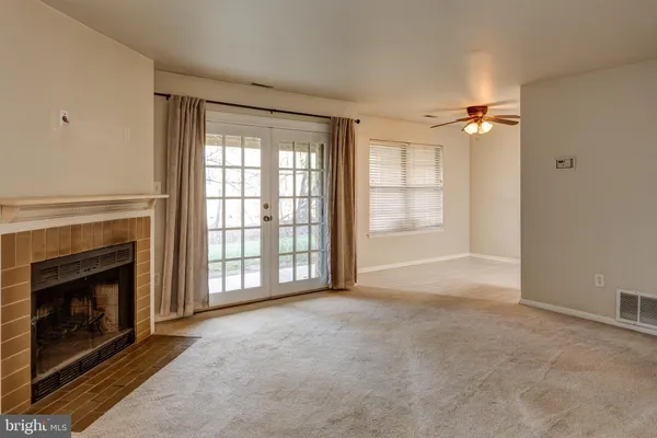 a kitchen with stainless steel appliances white cabinets and a refrigerator
