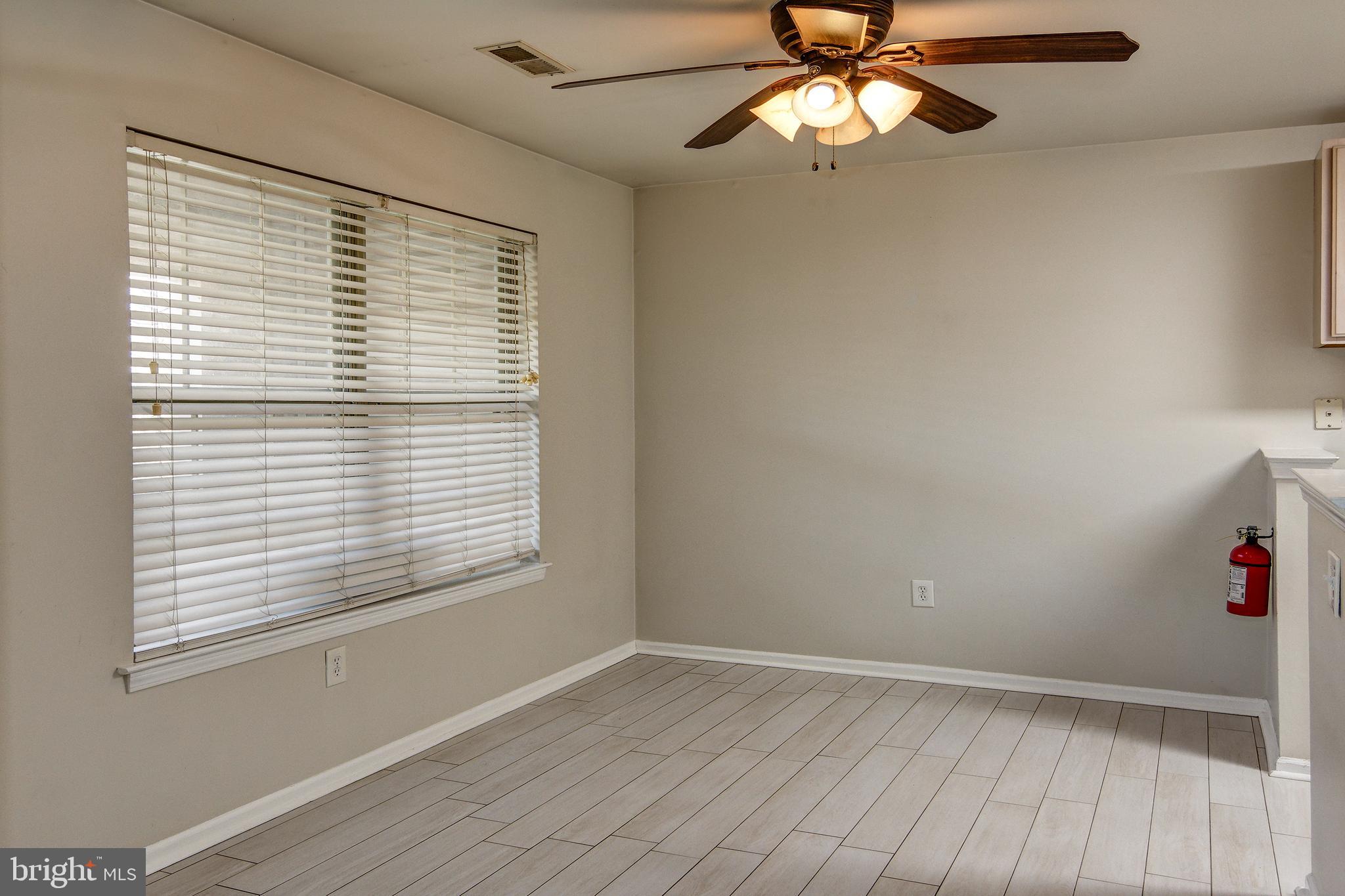 328 Tavistock Cherry Hill, NJ 08034 - Photo 10 of 23 a view of an empty room with a window and wooden floor