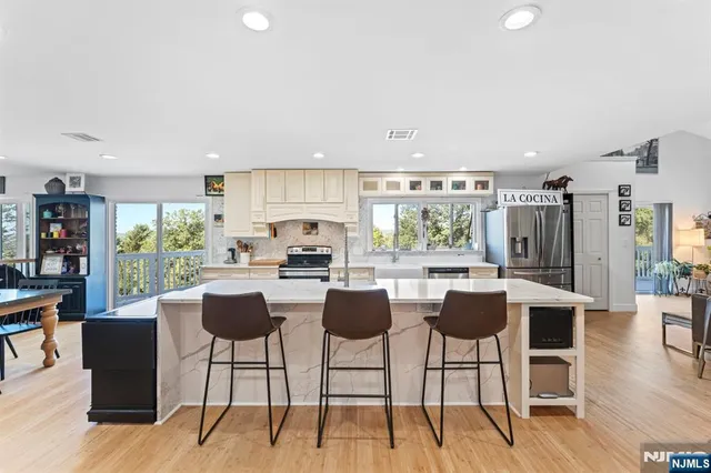a view of a workspace with furniture and a flat screen tv