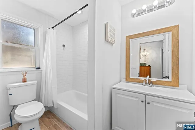 a view of a patio with a dining table and chairs with wooden floor and fence