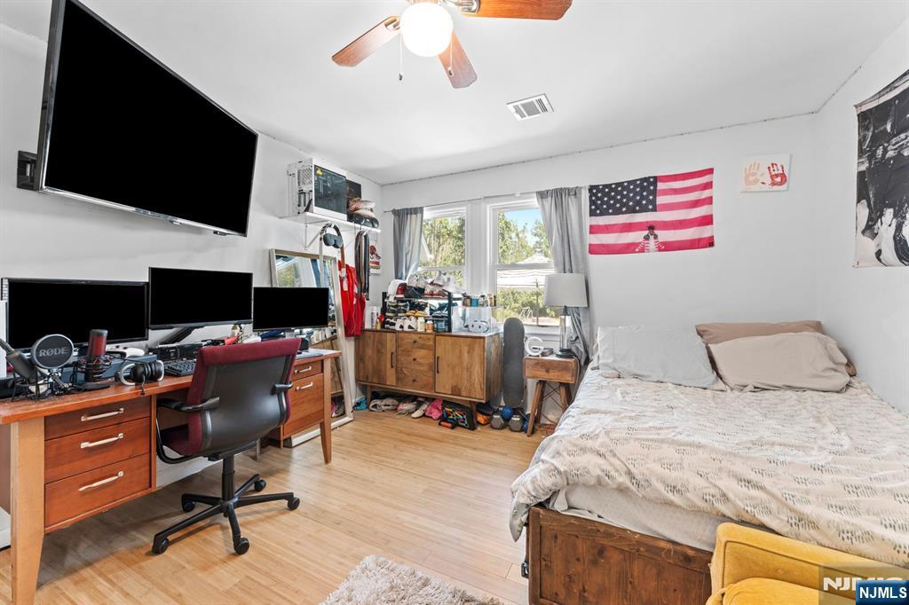 1 Rossi Drive Clinton, NJ 08809 - Photo 19 of 44 a view of a workspace with furniture and a flat screen tv