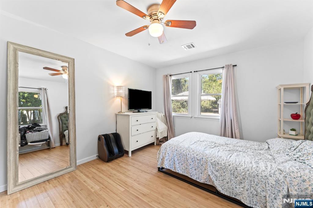 1 Rossi Drive Clinton, NJ 08809 - Photo 24 of 44 a bedroom with a bed and a flat screen tv