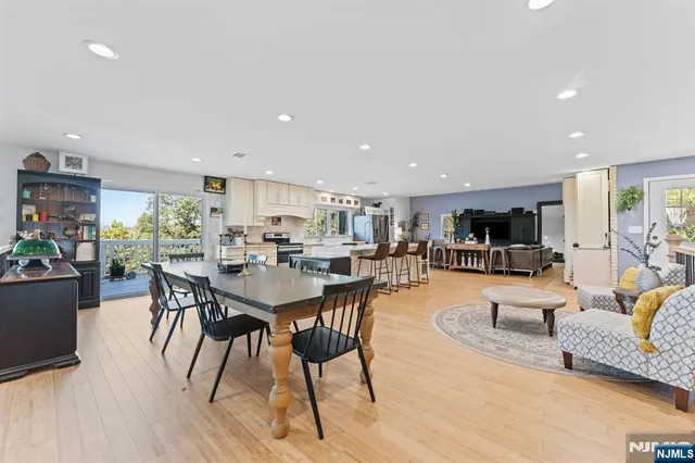 a living room with lots of furniture and kitchen view