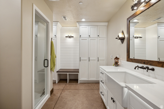 6117 North Rocky Ridge Road Peoa, UT 84061 - Photo 60 of 82 Spacious bathroom featuring a double vanity with integrated sinks, white countertops, and wall-mounted faucets