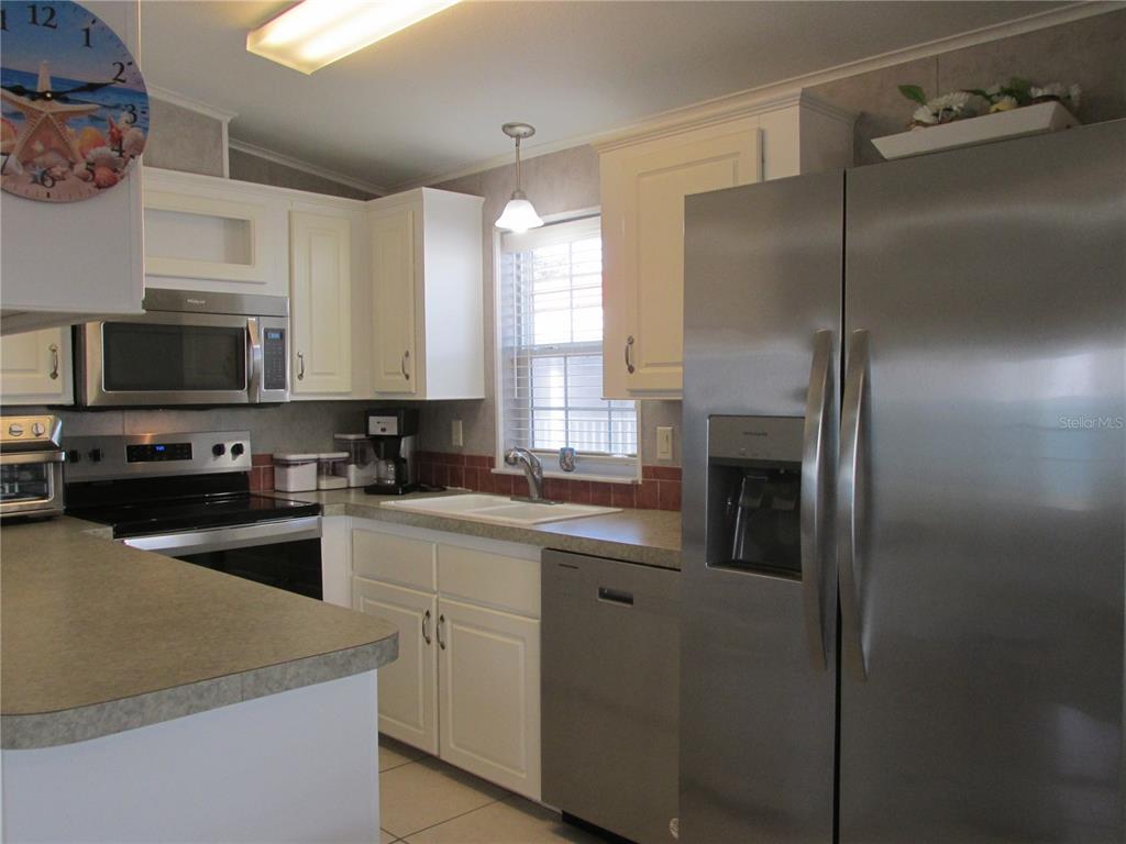 12 Saddle Bag Road Lake Wales, FL 33898 - Photo 7 of 34 a kitchen with a sink stainless steel appliances and cabinets