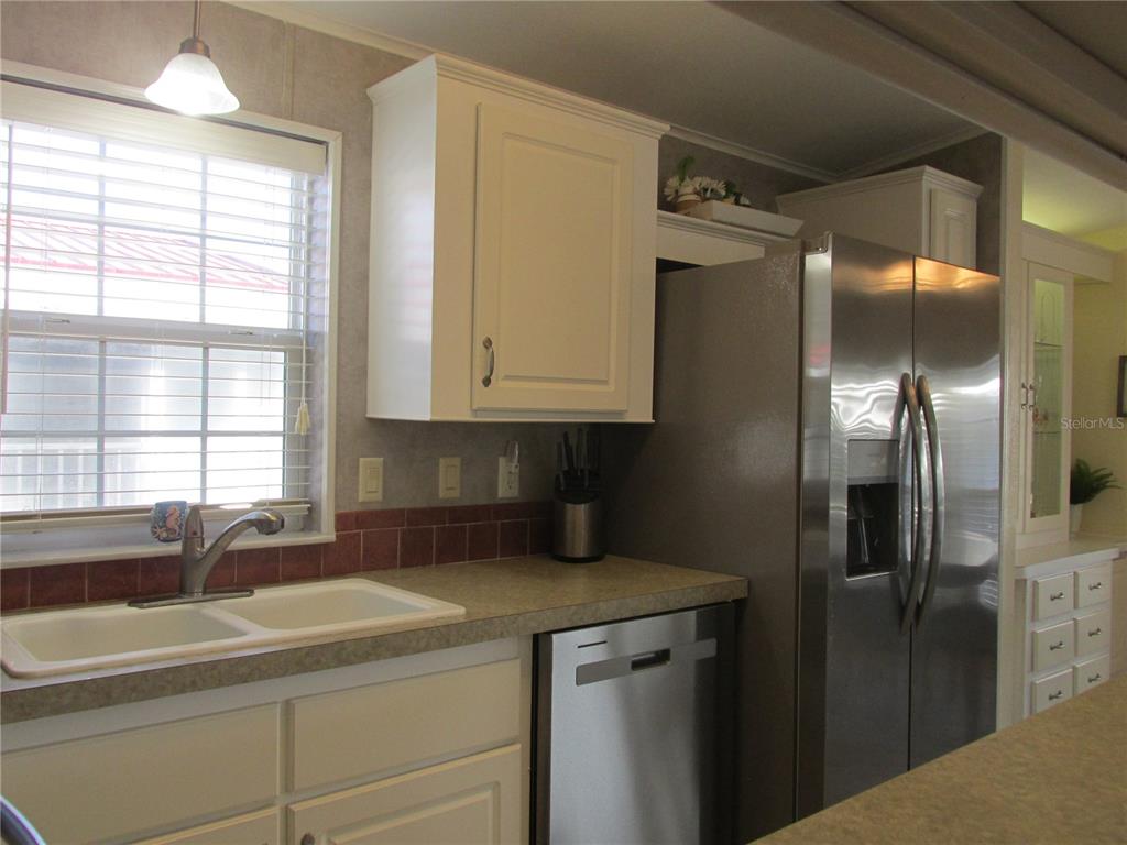 12 Saddle Bag Road Lake Wales, FL 33898 - Photo 10 of 34 a kitchen with a refrigerator and a sink