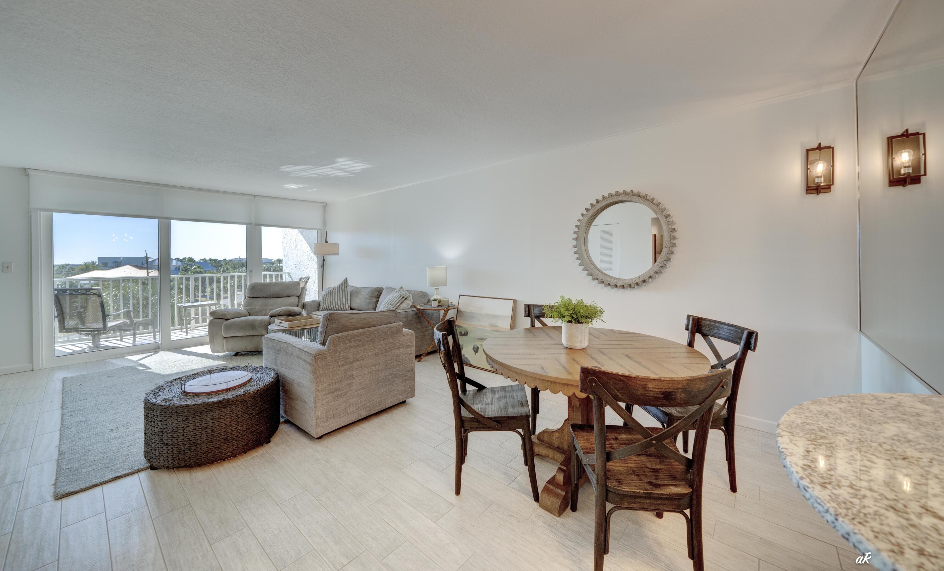 30 Moreno Point Road, Unit 404A Destin, FL 32541 - Photo 9 of 52 a dining room with furniture and a large window