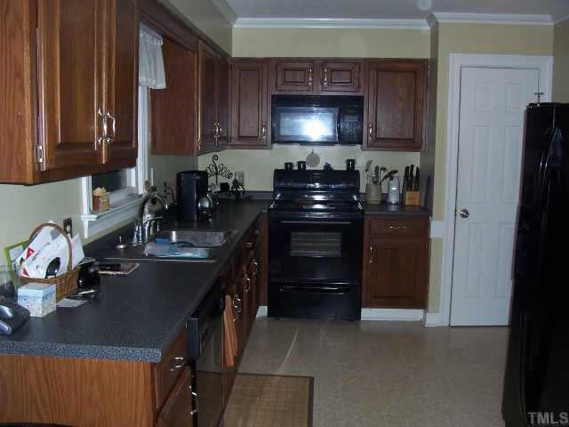 4509 Tetbury Place Raleigh, NC 27613 - Photo 7 of 12 Kitchen was updated in 2003 to include Brushed Nickel Hardware, New Countertops, Sink, Faucet, Garbage Disposal, Microwave, Electric Range, Flooring and Lighting Other