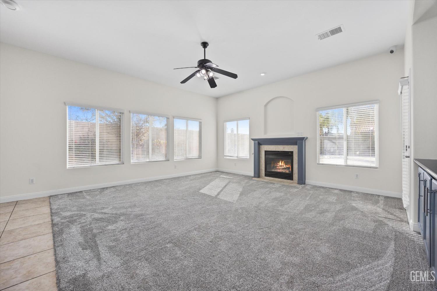 Undisclosed Address Bakersfield, CA 93313 - Photo 15 of 44 an empty room with windows and fireplace