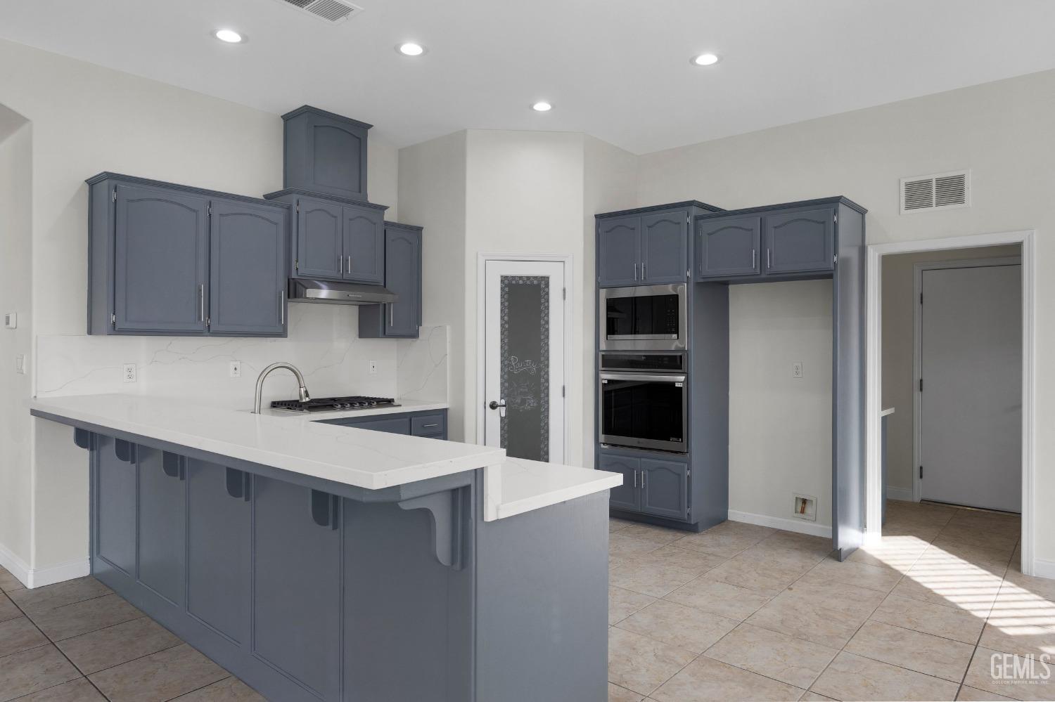 Undisclosed Address Bakersfield, CA 93313 - Photo 18 of 44 a kitchen with stainless steel appliances a refrigerator and a stove top oven