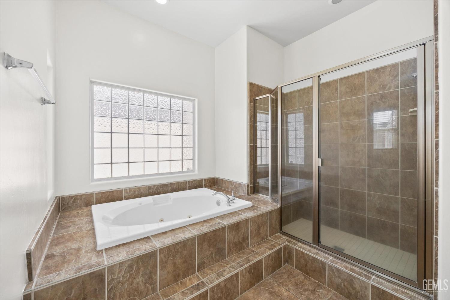 Undisclosed Address Bakersfield, CA 93313 - Photo 32 of 44 a bathroom with a granite countertop sink a toilet and shower