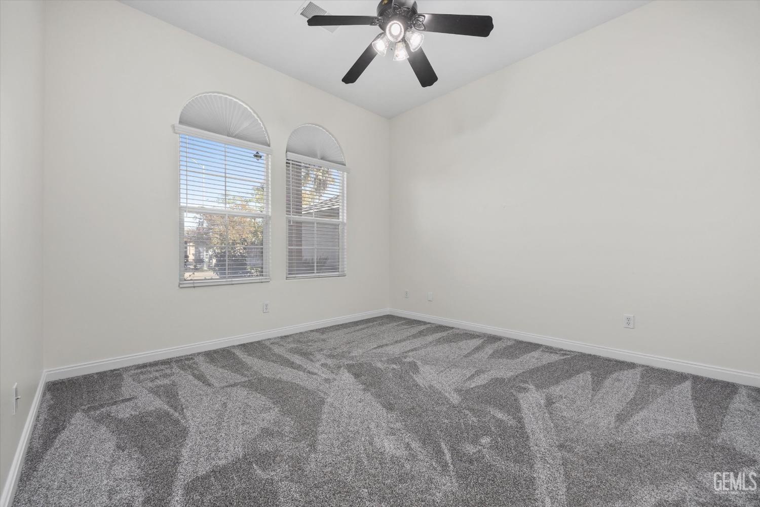 Undisclosed Address Bakersfield, CA 93313 - Photo 34 of 44 an empty room with a window and a fan