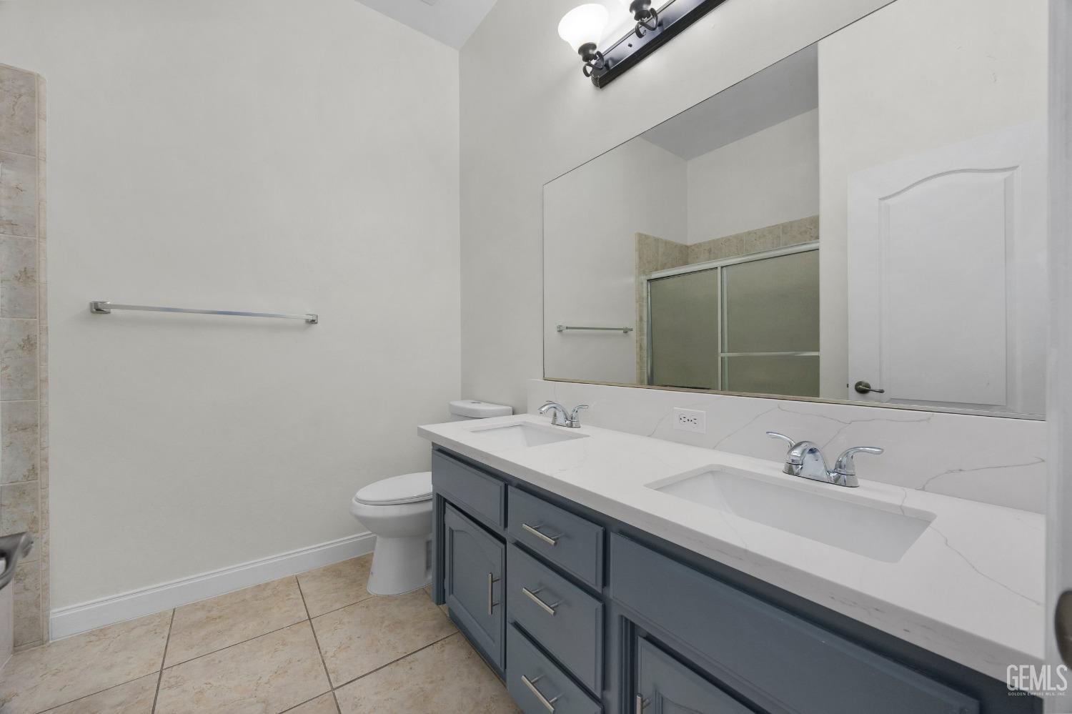 Undisclosed Address Bakersfield, CA 93313 - Photo 36 of 44 a bathroom with a sink a toilet and mirror