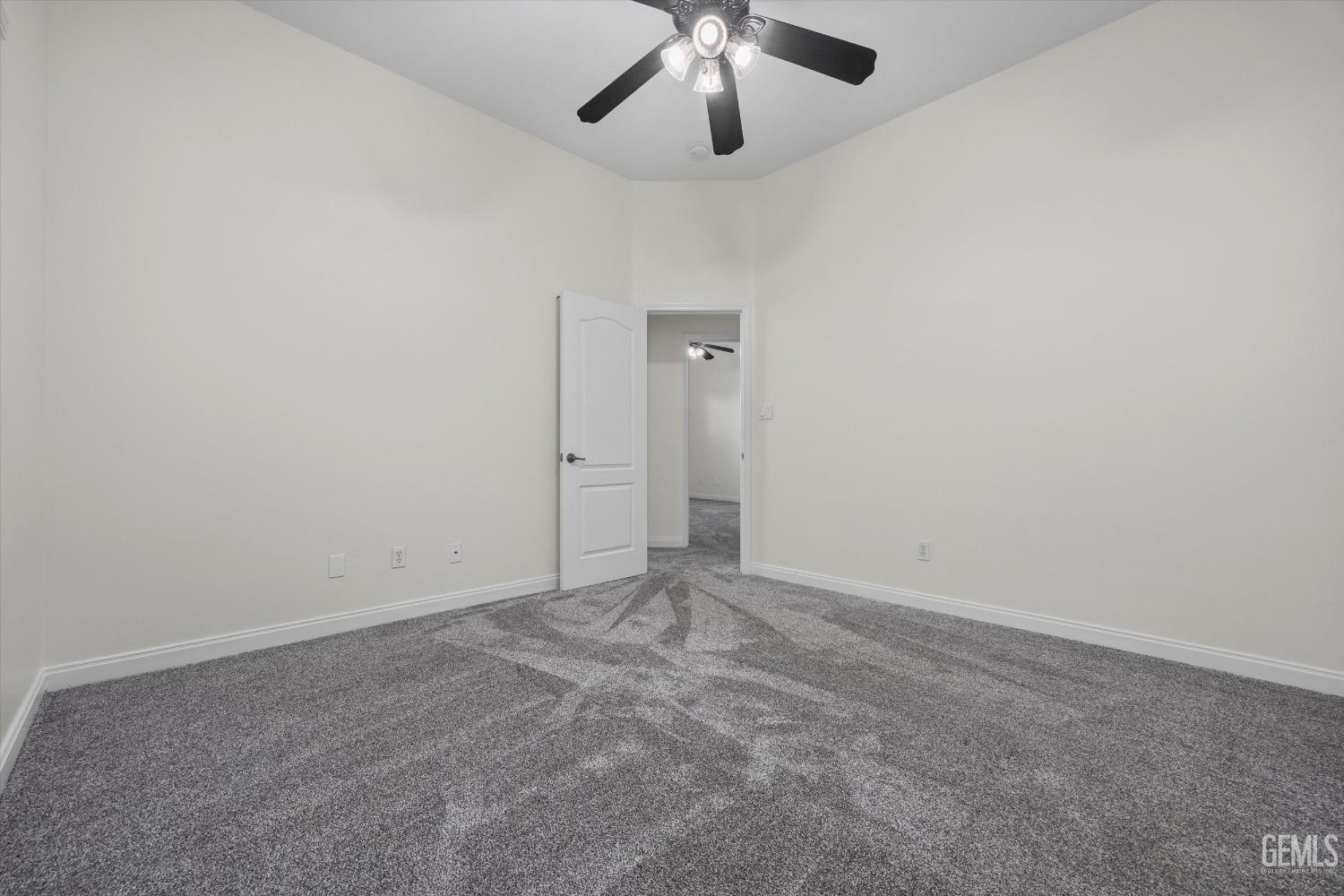 Undisclosed Address Bakersfield, CA 93313 - Photo 39 of 44 an empty room with chandelier fan
