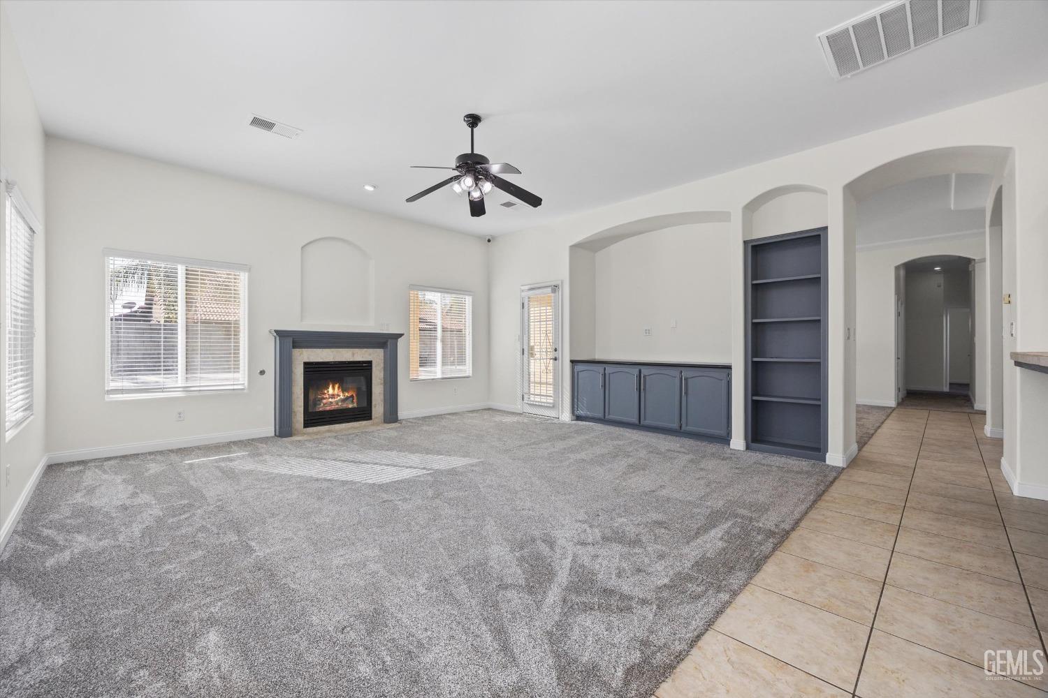 Undisclosed Address Bakersfield, CA 93313 - Photo 9 of 44 a view of an empty room with a fireplace and a window