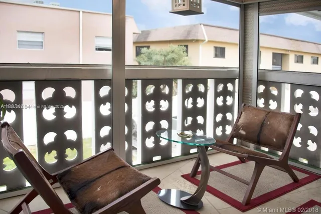 a living room with furniture and floor to ceiling window