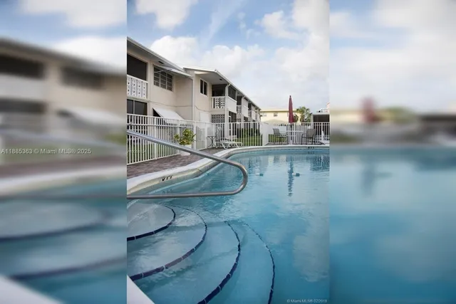 a city view from a balcony with outdoor seating