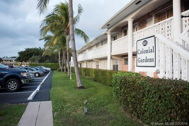 a front view of a house with plants