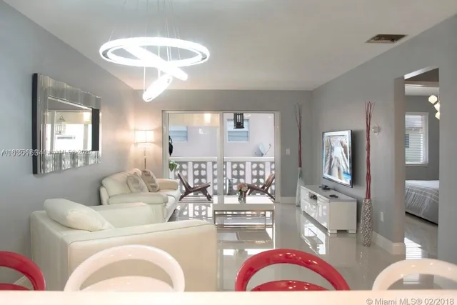 a living room with furniture and a large mirror