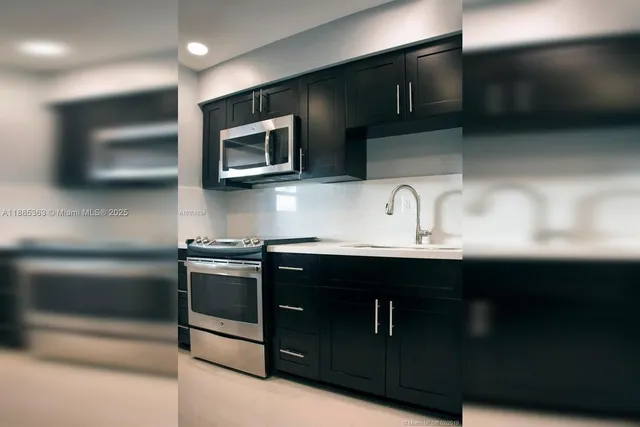 a kitchen with stainless steel appliances wooden cabinets a sink and a microwave