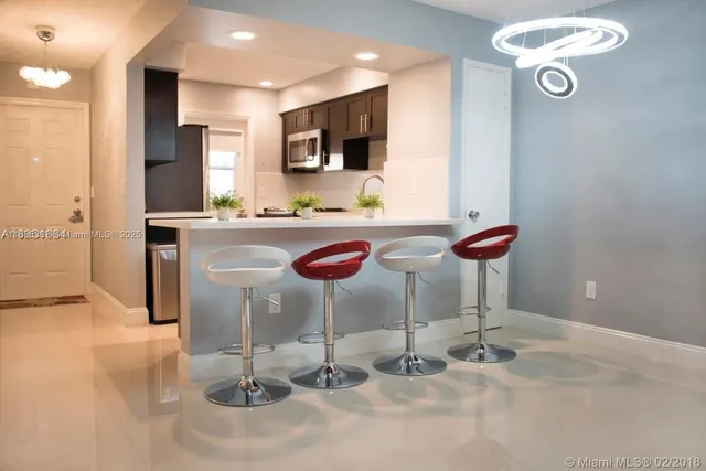 a kitchen with stainless steel appliances granite countertop a sink and a refrigerator