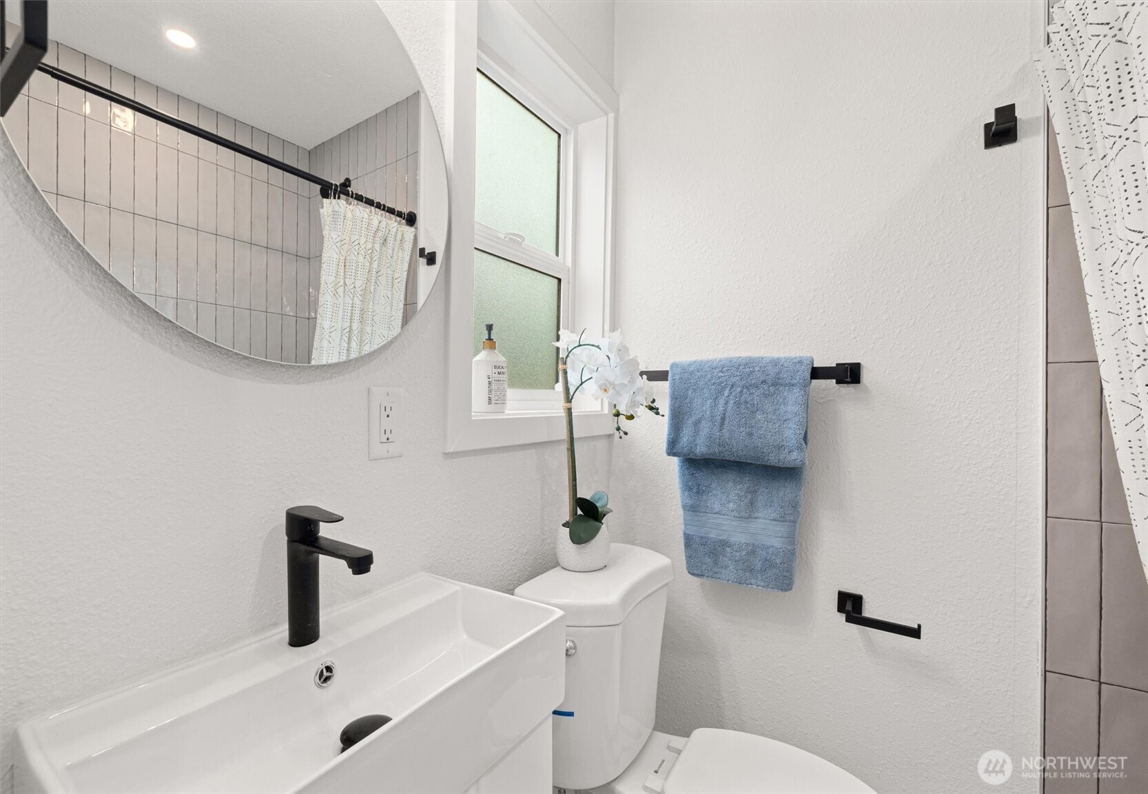 1310 North 3rd Street Renton, WA 98057 - Photo 11 of 16 a bathroom with a sink a toilet and a mirror