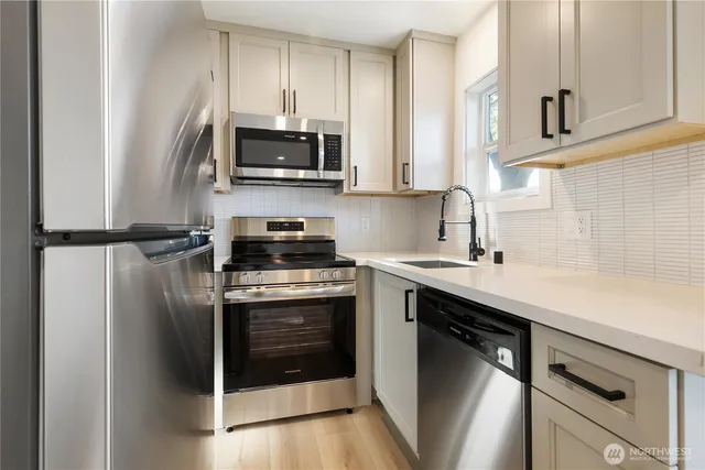 a kitchen with a sink and stainless steel appliances