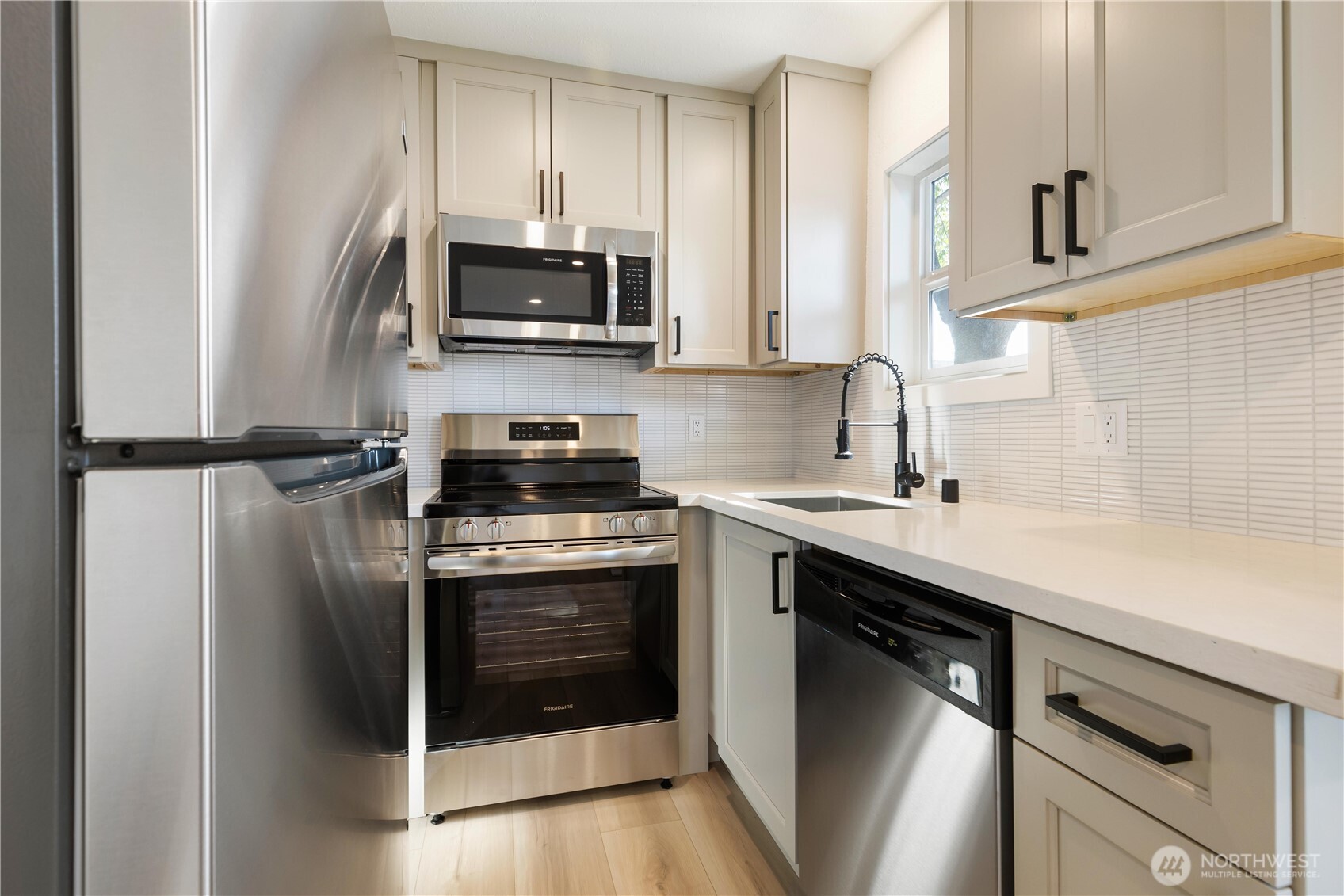 1310 North 3rd Street Renton, WA 98057 - Photo 7 of 16 a kitchen with a sink and stainless steel appliances