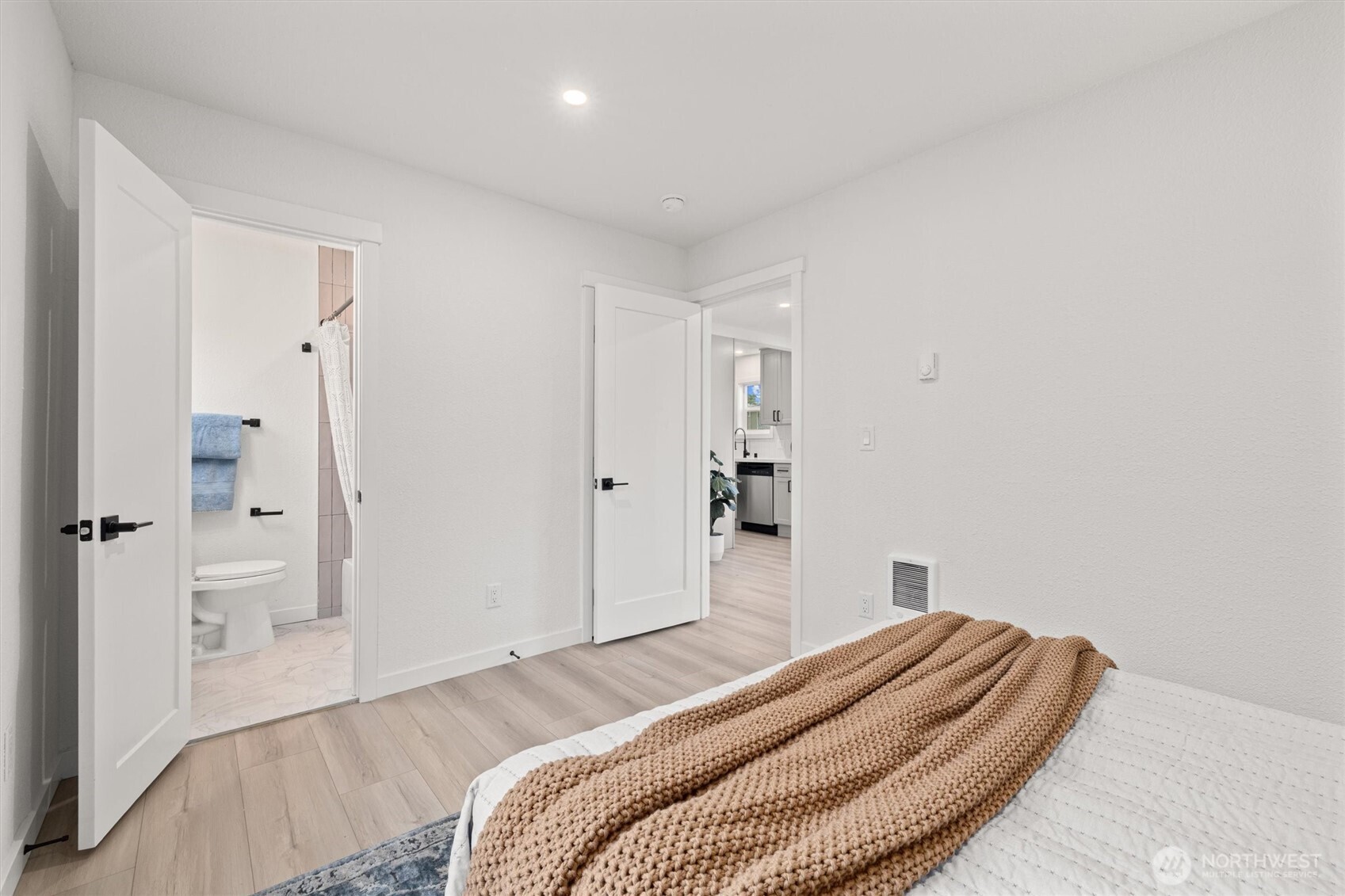 1310 North 3rd Street Renton, WA 98057 - Photo 10 of 16 a bedroom with a bed and a chandelier