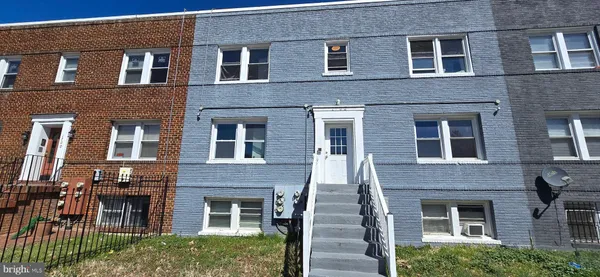 a front view of a house with many windows