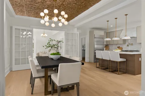 a view of a dining room with furniture and chandelier