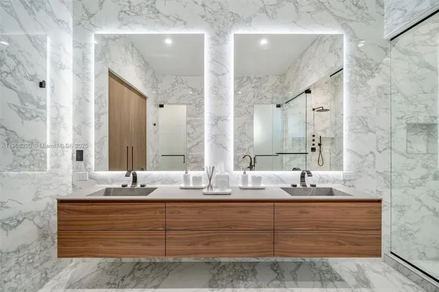 a bathroom with double vanity sinks and a mirror